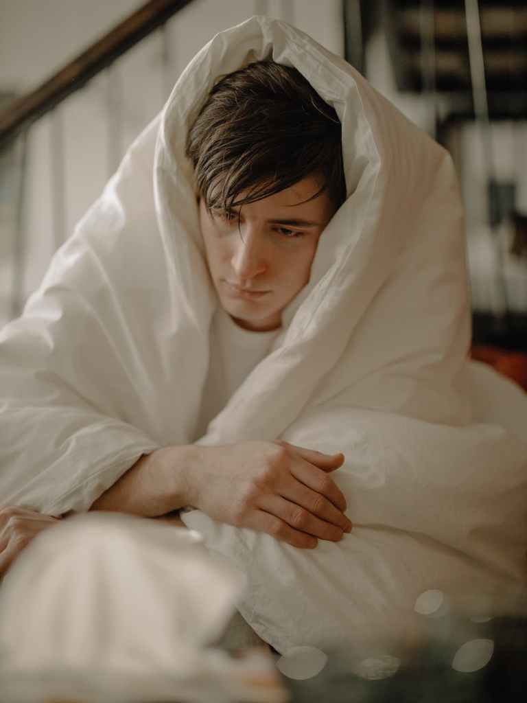 A man looking ill and wrapped in a duvet.10 ways how to look after your awesome immune system.