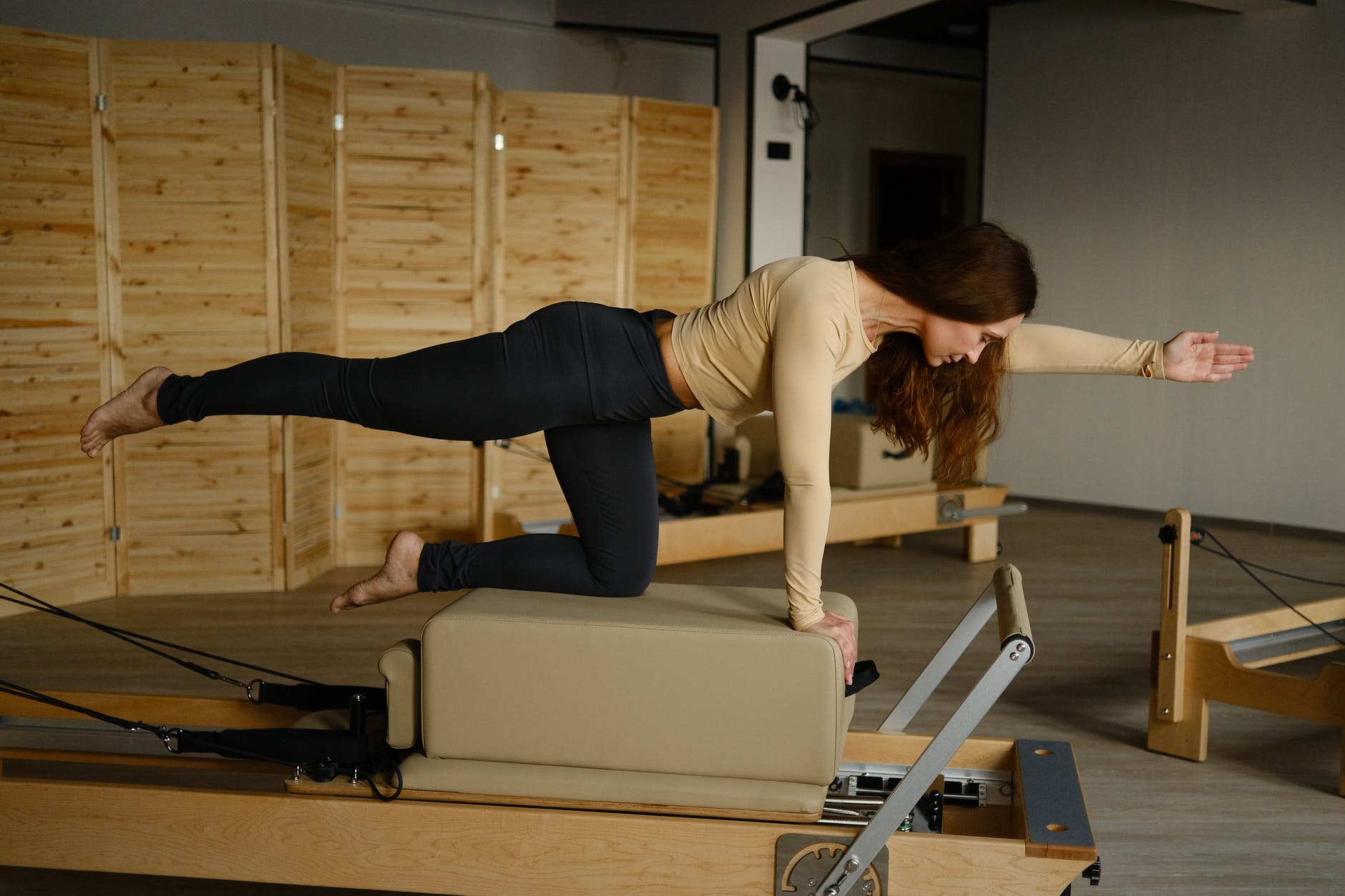A woman performing a yoga position. The Awesome Effects of Exercising on Your Body.
