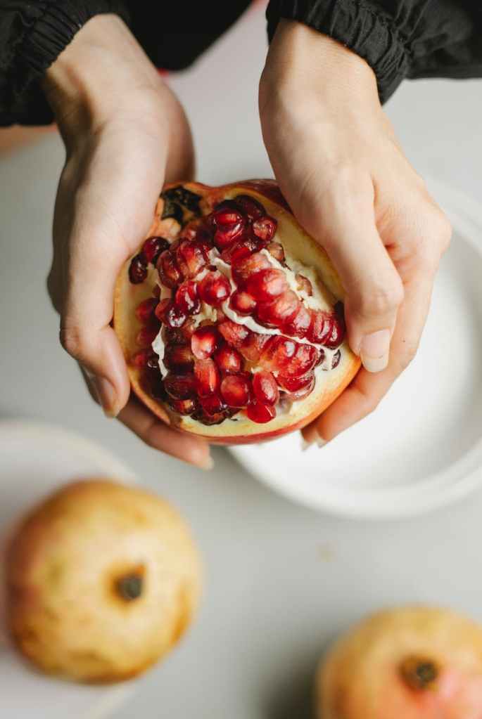 The image shows hands holding a pomegranate.
Intriguing facts about pomegranates and 7 wonderful reasons why they're so good for you.
